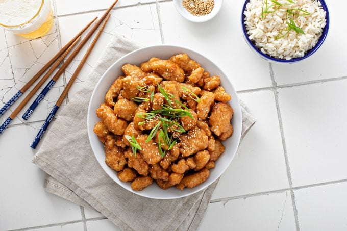 fried Chinese sesame chicken with green onions and sesame seeds