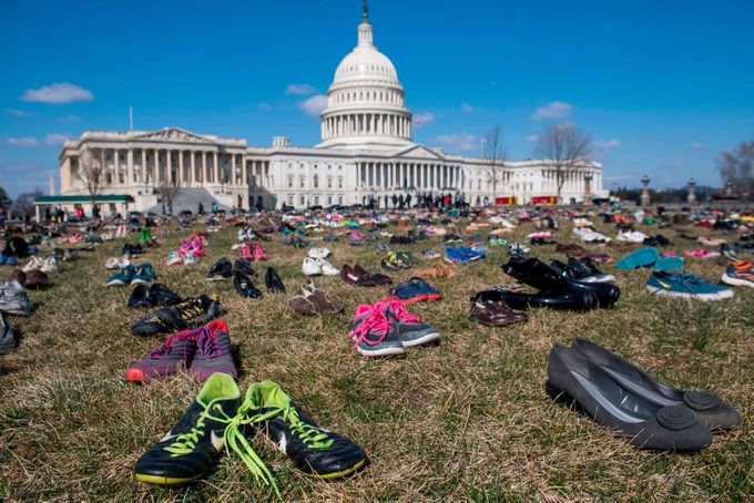 The lawn outside the US Capitol is covered with 7,000 pairs of empty shoes to memorialize the 7,000 children killed by gun violence since the Sandy Hook school shooting, in a display organized by the global advocacy group Avaaz, in Washington, DC, March 13, 2018.