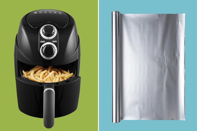 air fryer on a green background next to a roll of aluminum foil on a green background