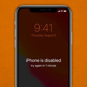 Disabled iPhone on an orange paper background