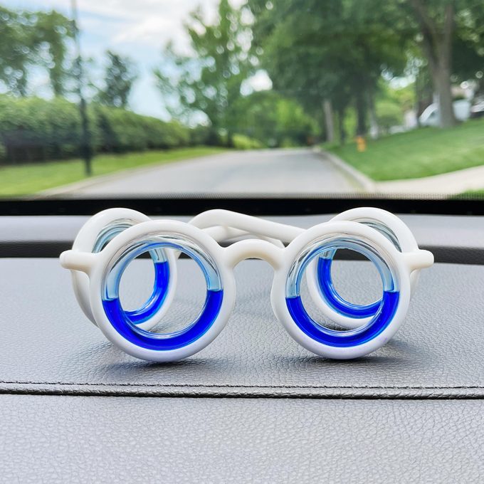 Motion Sickness Glasses on the dashboard of a car