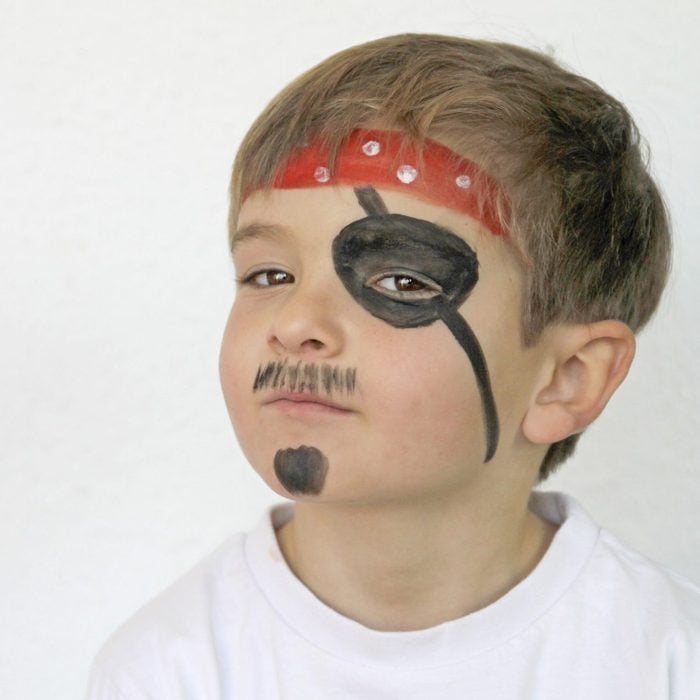 Portrait Of Boy dressed up in Pirate face paint for halloween