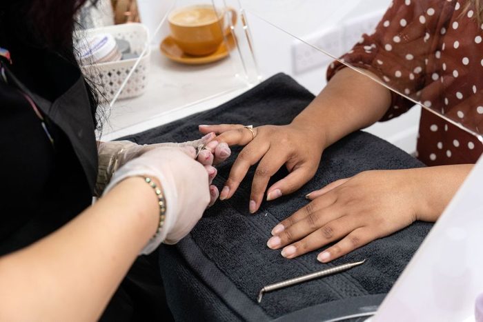 woman getting nails done at a nail salon