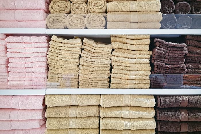 Stacked Soft Fluffy Towels On Shelves At Clothing Store