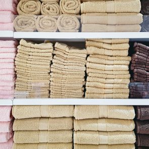 Stacked Soft Fluffy Towels On Shelves At Clothing Store