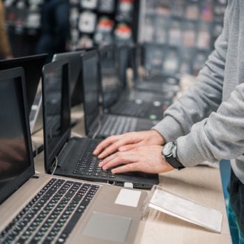 modern male customer choosing laptop in the computer store
