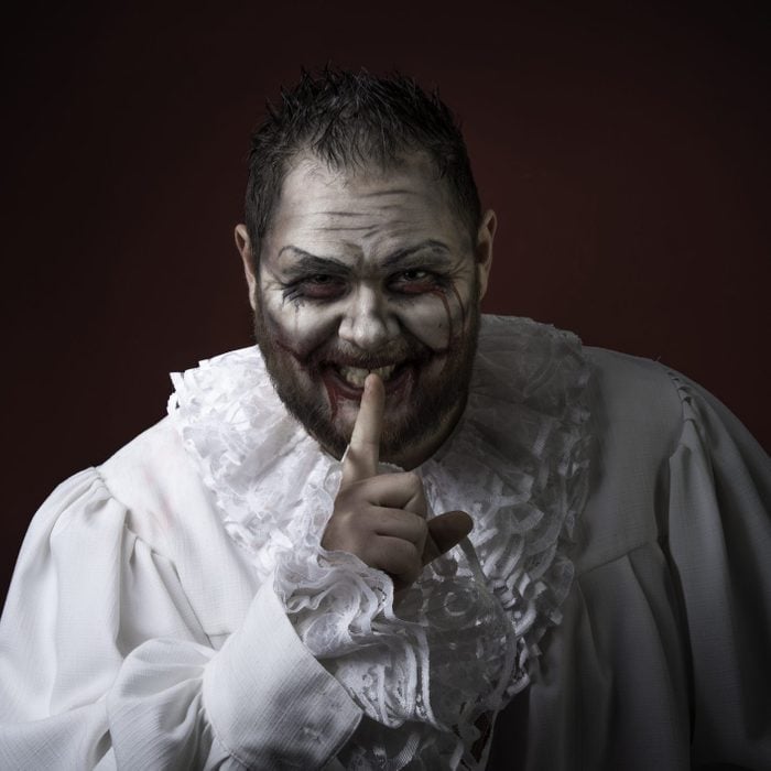 Portrait of a Scary Evil Clown. Studio shot with horrible face art