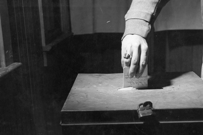 Close-up of a hand as it inserts a ballot into a box during the US Presidential election, Lancaster, Pennsylvania, November 2, 1948