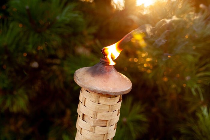 Tiki torch on fire during summer