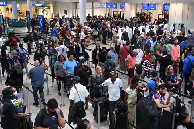 Travelers make their way through a TSA screening line at an airport in ORLANDO, FLORIDA, UNITED STATES