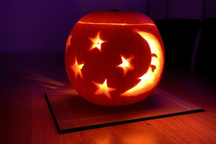Star and moon carved pumpkin lit