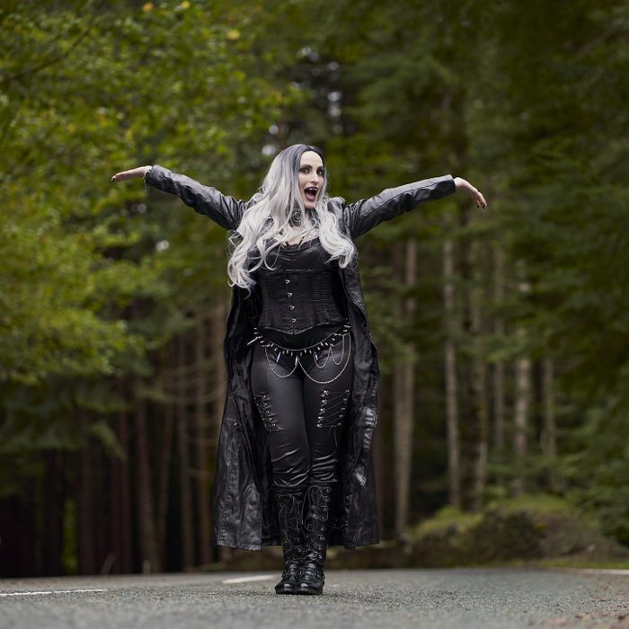 Woman in vampire costume outdoors.
