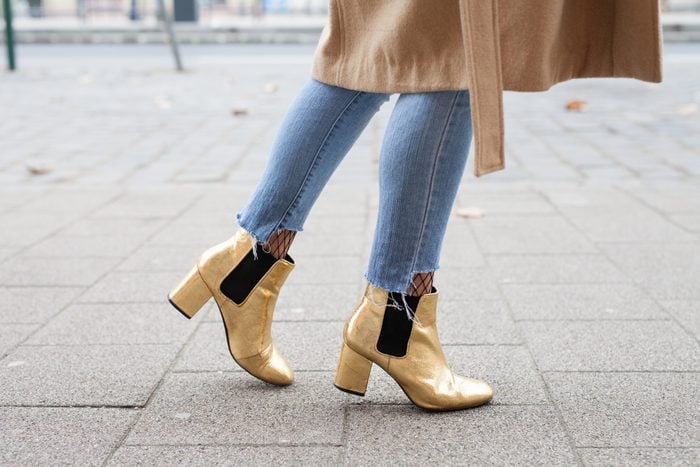 lower crop of a woman walking down the sidewalk with skinny jeans and high heels