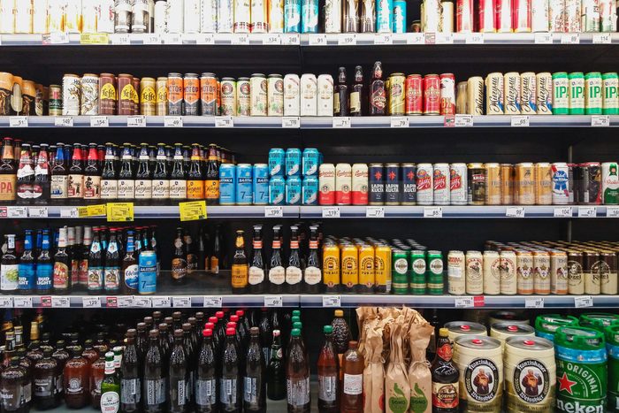 Beer in bottles and cans on grocery store shelves