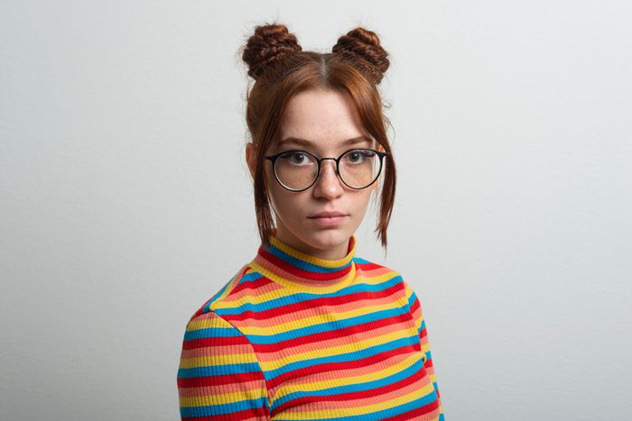 Woman with freckles ,glasses and chignon