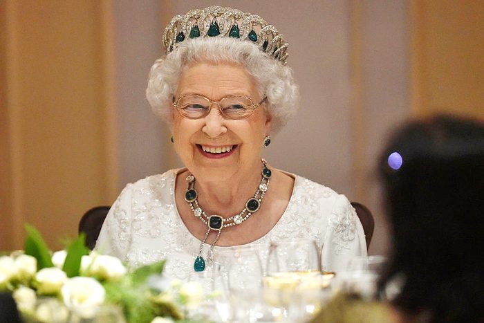 Queen Elizabeth sitting down for dinner