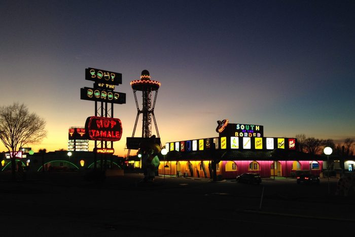 South of the Border at night with glowing lights and a faded sunset sky