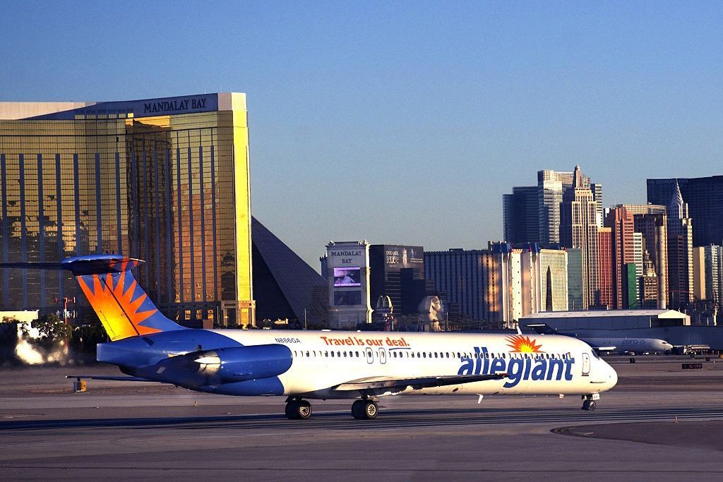 Allegiant Air passenger aircraft at Las Vegas international airport with a city skyline in the background