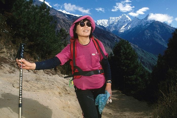 Portrait of Junko Tabei with a mountain landscape in the background