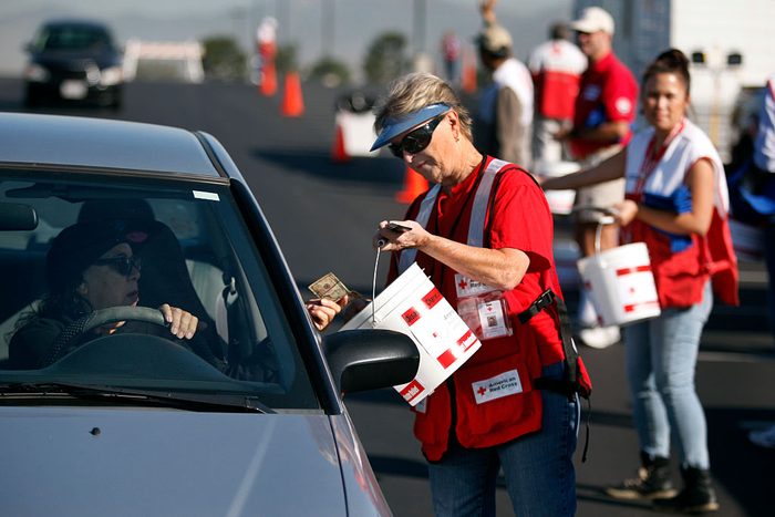 Linda Beltran, left, of Ahaheim, makes a cash donation to American Red Cross volunteer Dee Luna dur