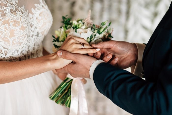 close up of hands exchanging of wedding rings between the bride and groom