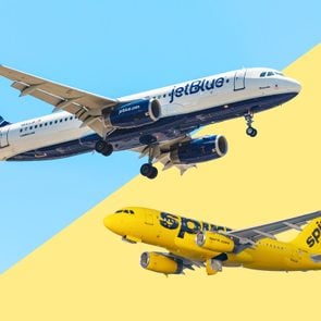 Jetblue plane over a spirit airlines plane with a split blue and yellow background
