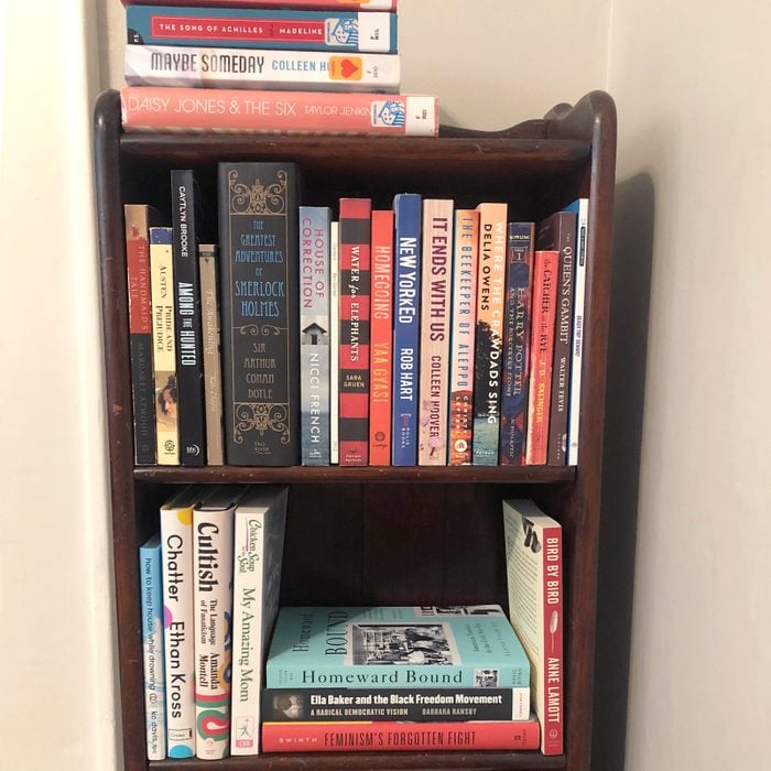 a small wooden bookcase filled with books