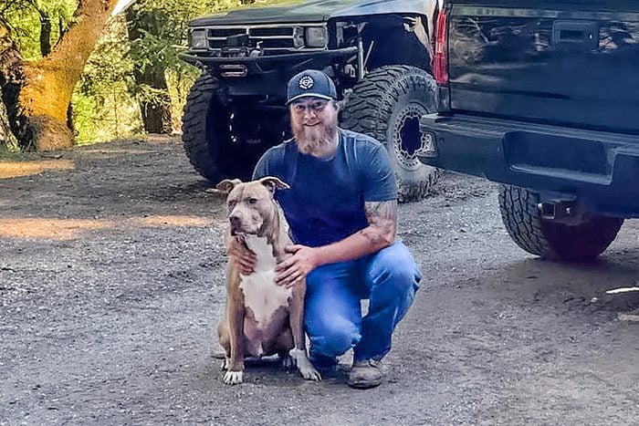 Kaleb Benham poses with his dog, Buddy, who is fully healed from the bear attack