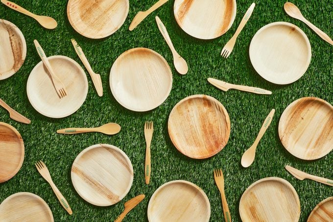 bamboo plates, forks, and spoons on a grass background
