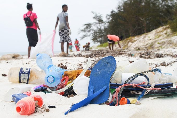 Volunteers collect plastic waste during a cleaning exercise organized by Ocean Sole Africa, in Kilifi county, Kenya, on February 12, 2022