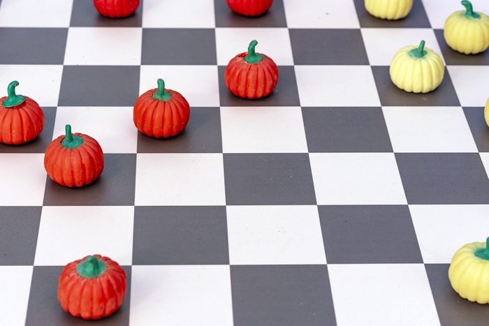 Game board with checkers in the form of orange and yellow pumpkins.