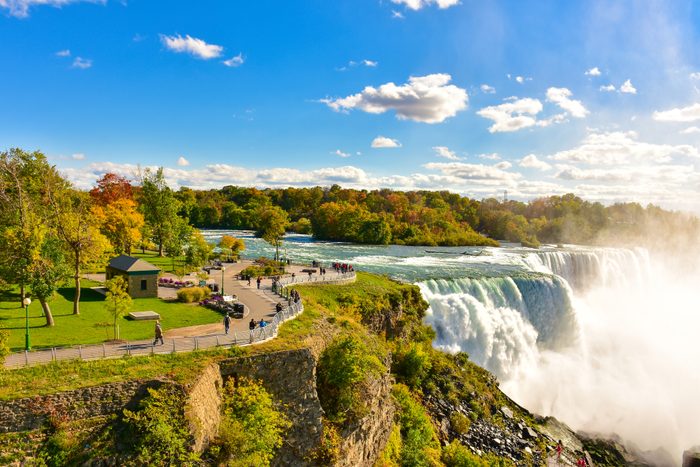 Niagara Falls American Falls with autumn leaf colors on a sunny autumn day