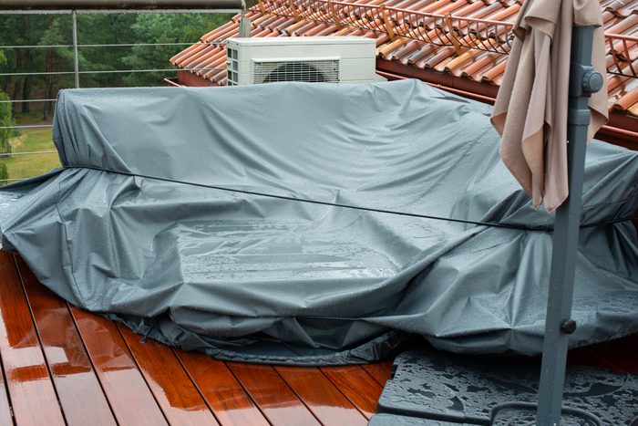 Terrace furniture Cover protecting outdoor furniture from rain.