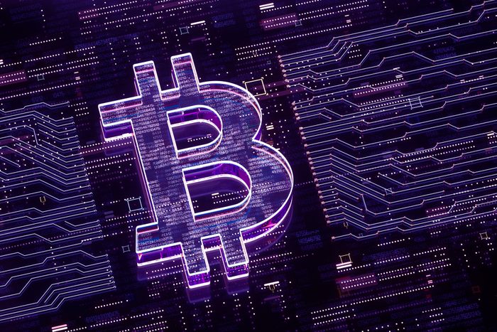 Digital generated image of bitcoin sign over glowing digital circuit board.