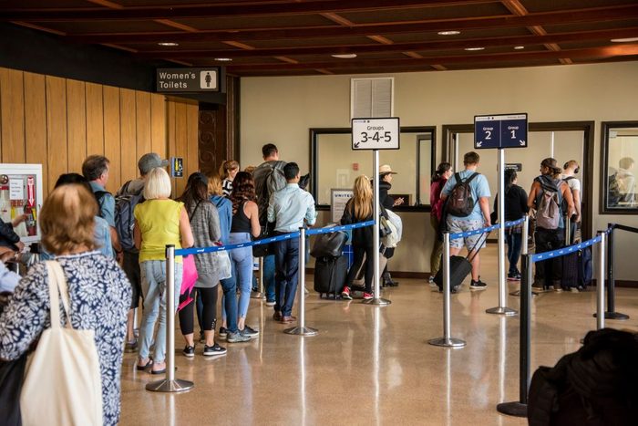 People in line boarding their airplane at the Daniel K. Inouye International Airport in Honolulu Hawaii.
