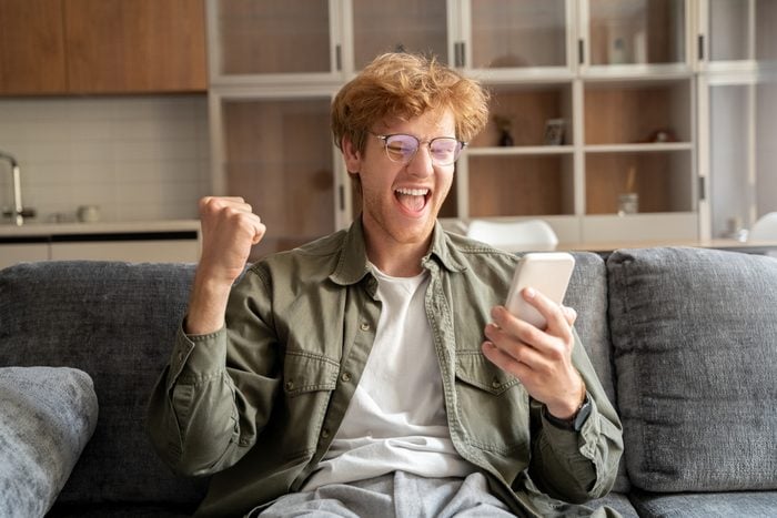 Excited young irish ginger man gesturing yes to mobile webcam