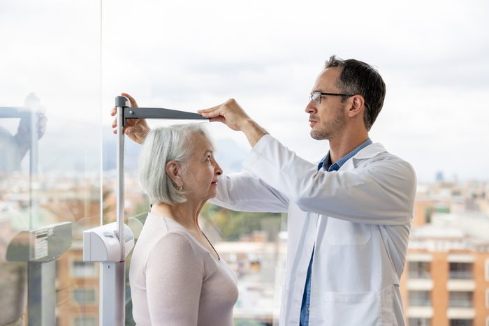 Doctor examining a senior woman in his office