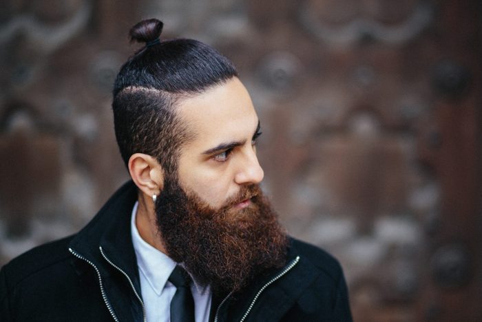 Portrait of a man with a beard and his hair in a bun