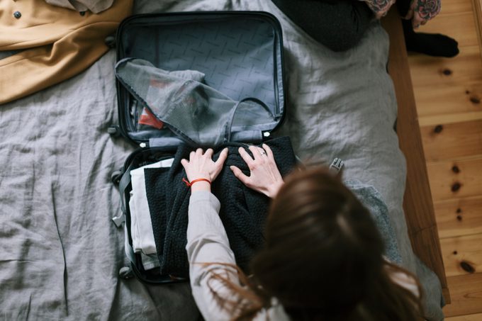 Woman packing a Suitcase