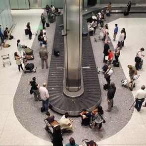Passengers wait in the baggage hall at terminal five at Heathrow airport on August 27, 2010 in London, England