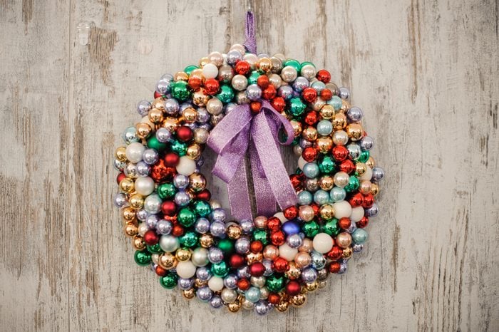 Colorful Christmas wreath decoration baubles on wooden background