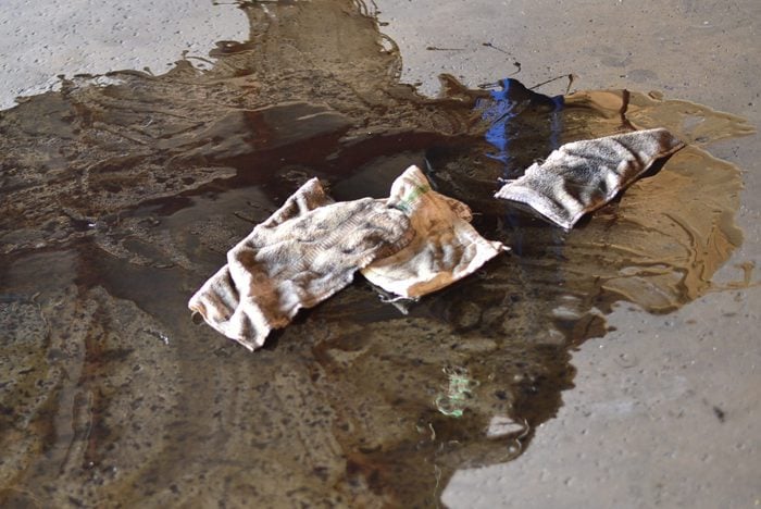 smeared puddle of oil with dirty rags