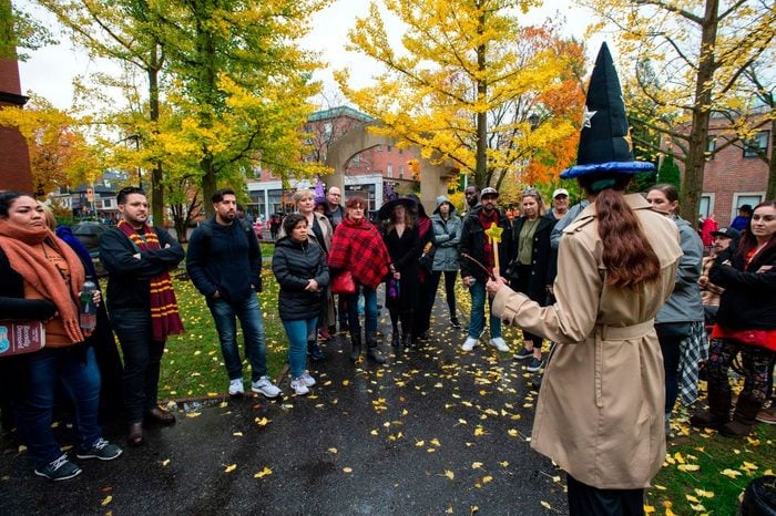 Tourist listen to a tour guide at a ghost tour during Halloween In Salem