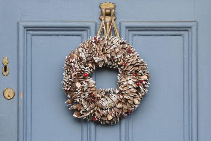 Christmas wreath made of pinecones on a blue front door in dublin