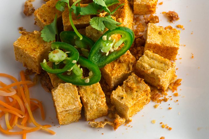 Tofu, cubed and seasoned with soy sauce, Asian spices and fried. Served in Classic traditional Chinese, Vietnamese or Thai restaurant garnished with pickled jalapenos, carrots and cabbage.