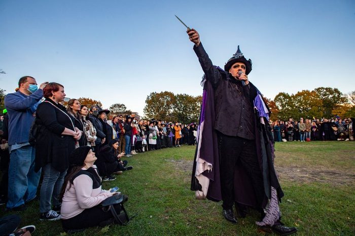Witch Christian Day holds out a knife as he marches around the circle during the Witches' Magic Circle in the common on Halloween in Salem