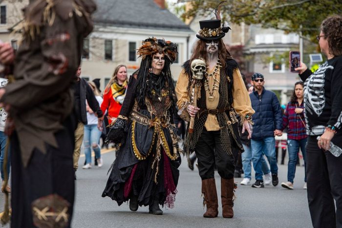Jack Rotaoli and Marjorie Rio walk dressed as voodoo witch doctors on Halloween in Salem, Massachusetts on October 31