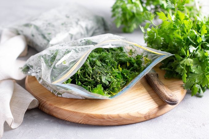 Frozen parsley in a plastic bag. Frozen vegetables