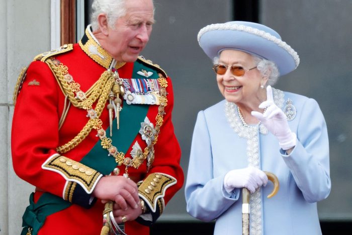 Prince Charles, Prince of Wales (wearing the uniform of Colonel of the Welsh Guards) and Queen Elizabeth II watch a flypast from the balcony of Buckingham Palace during Trooping the Colour on June 2, 2022 in London