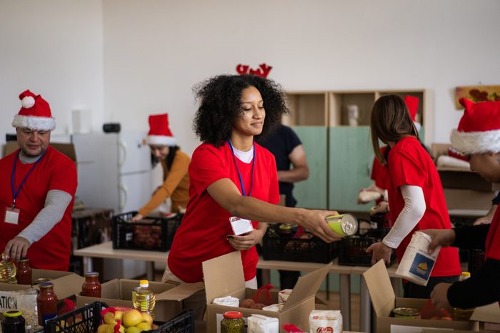 Festive volunteers packing groceries at food bank